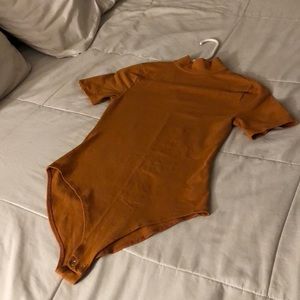 Burnt orange body suit